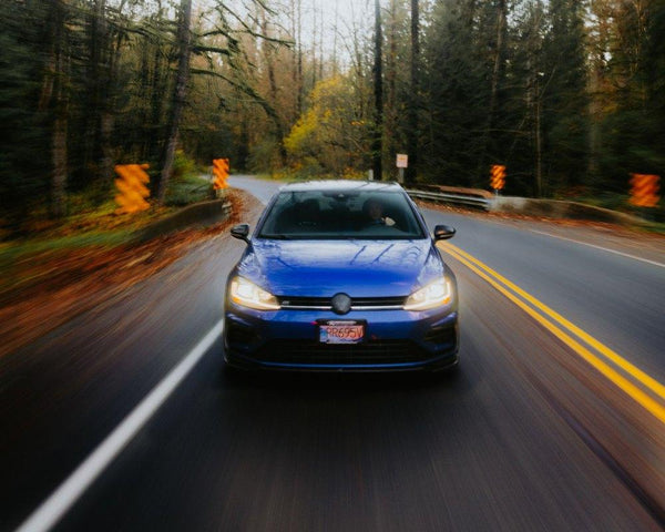 Car driving on a forest road