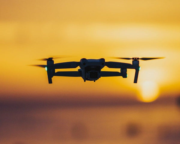 Drone in flight at sunset